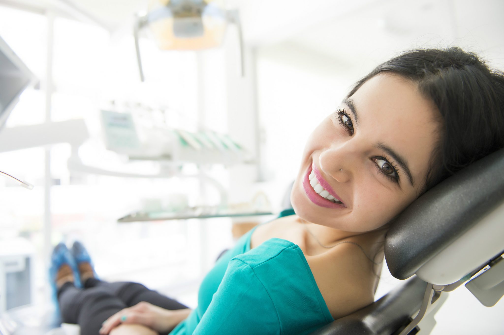 female laying down on dentist chair at top cosmetic dentist in san mateo